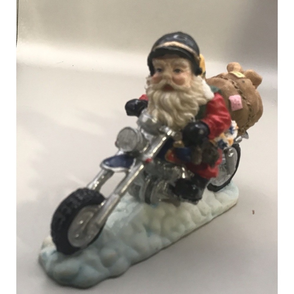 Santa On A Motorcycle With Sack Of‎ Gifts Going Skiing
